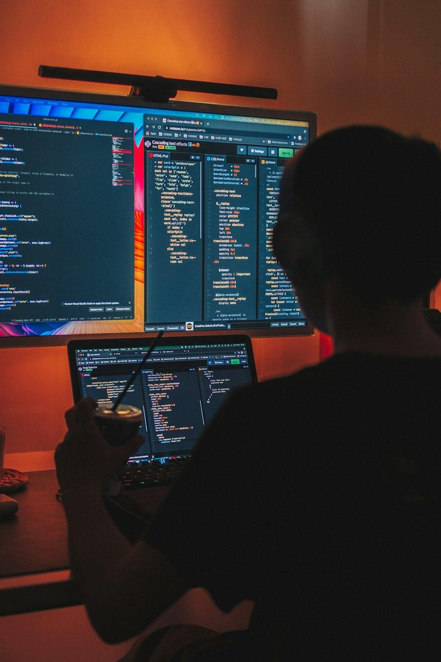A developer working late at two screens full of code