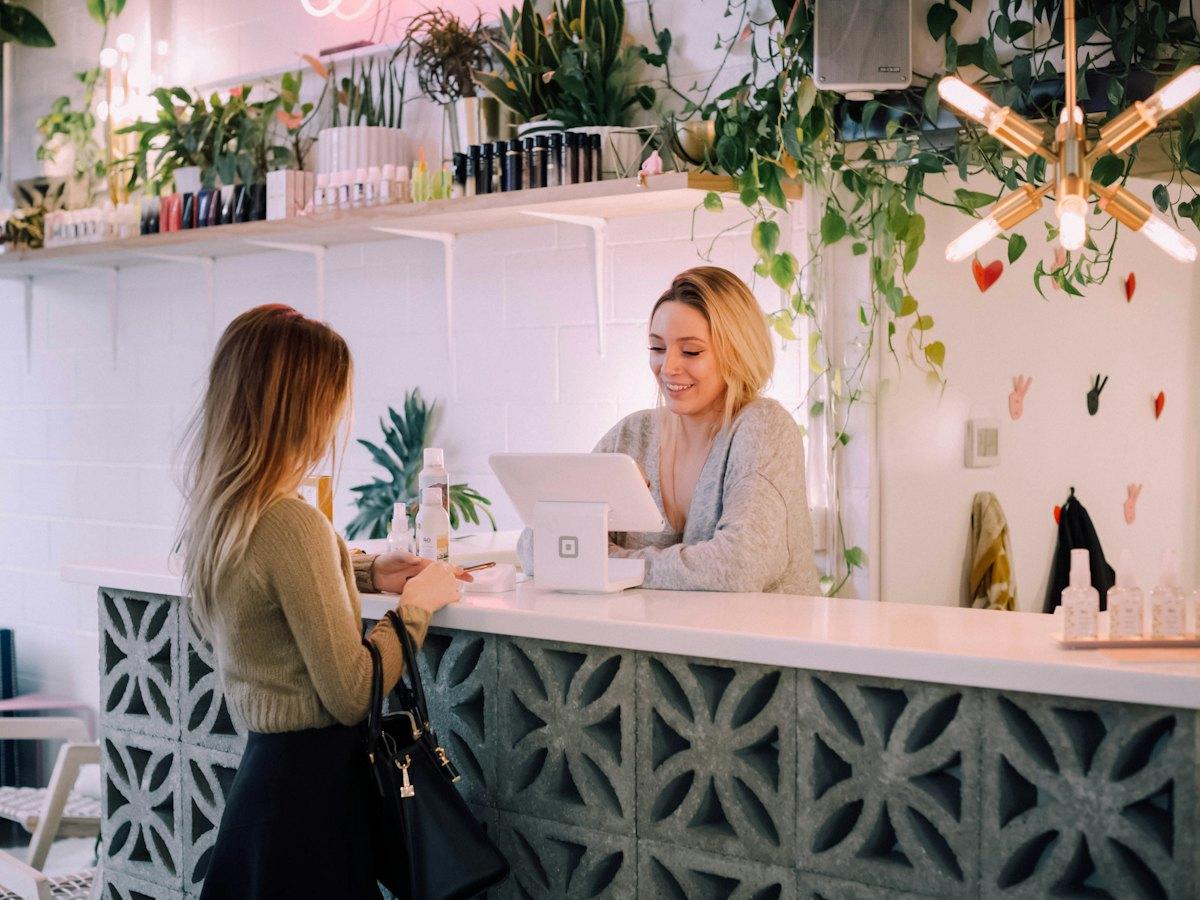 Kunde betaler ved disken i en butik med planter