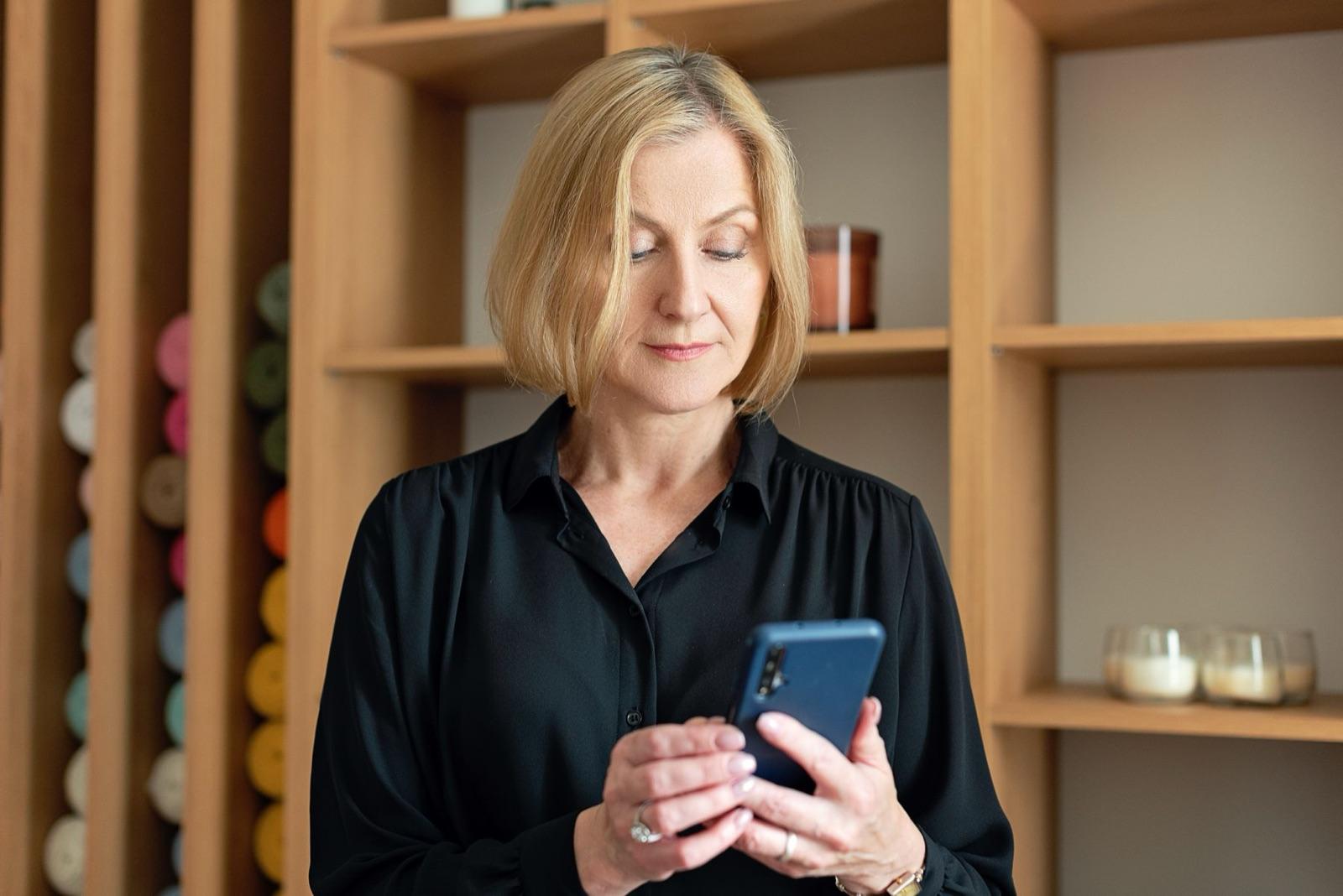 A decision maker reading a message on her phone